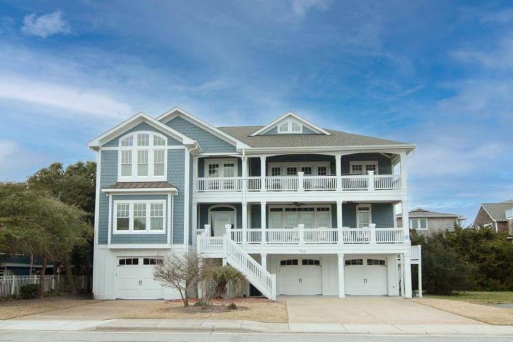 a large, blue beach house in wrightsvill ebeach